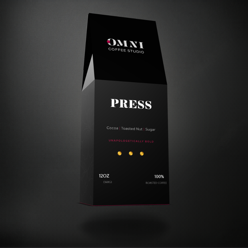 Press dark roast specialty coffee packaging showing roast level by Omni Coffee Studio, left view on dark background.