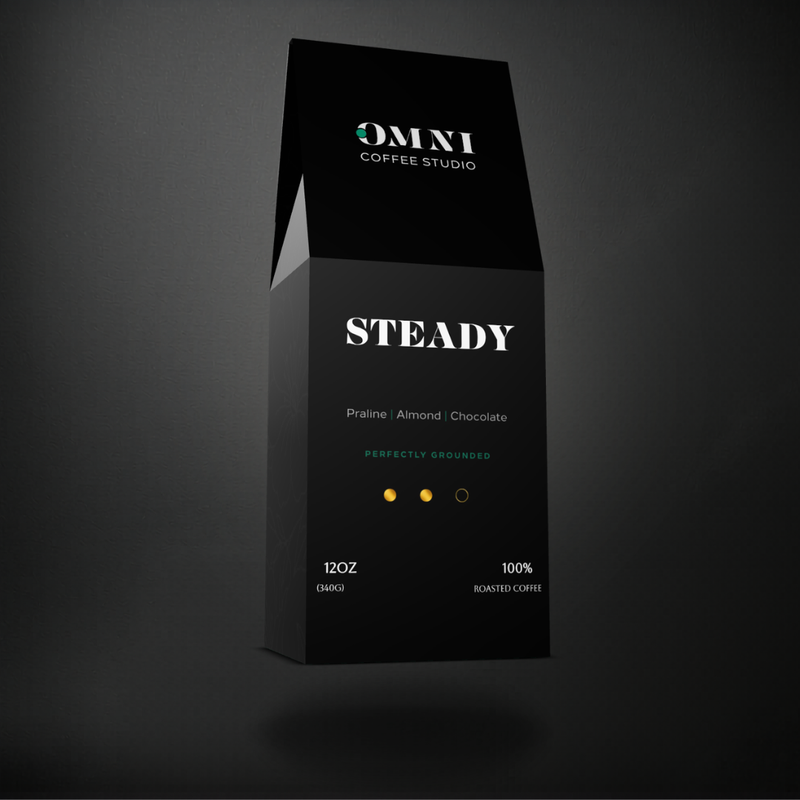 Steady medium roast specialty coffee packaging showing roast level by Omni Coffee Studio, left view on dark background.
